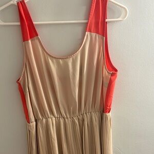 C. Luce Vibrant Orange and Cream Dress with mini pleated skirt